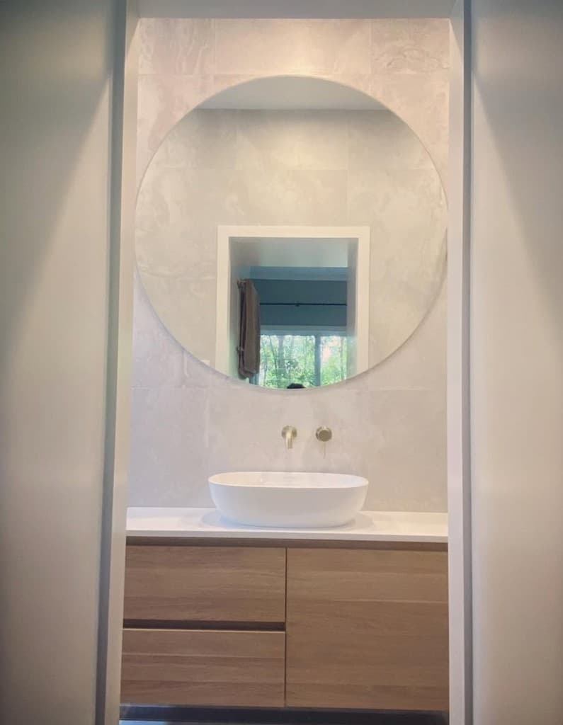 Floating timber vanity with vessel basin and brushed gold tapware